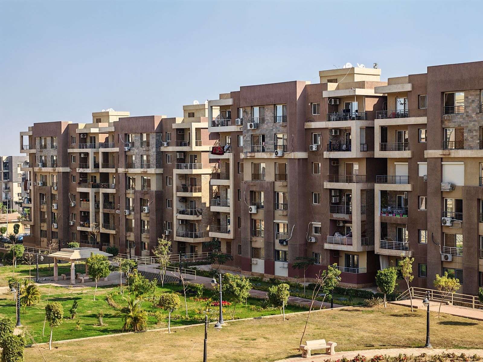 Mid-rise apartment buildings with lawns and walkways (stock photo)