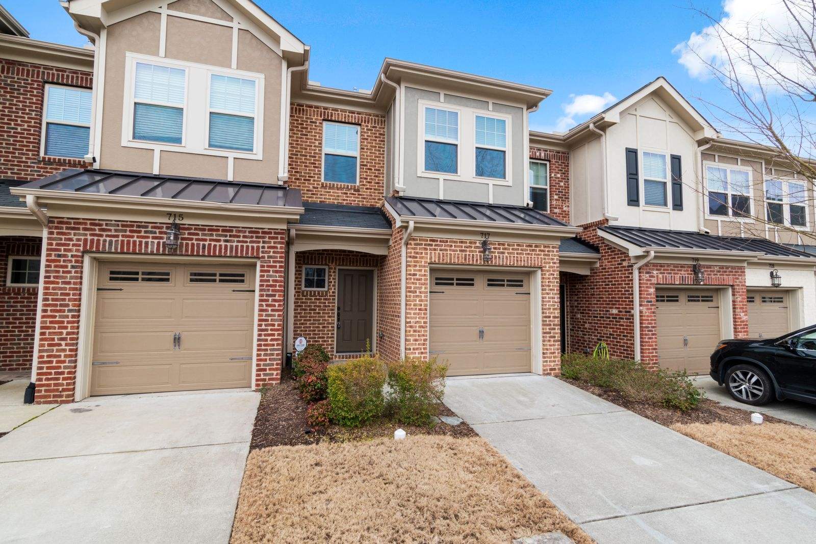 Brick townhomes with short concrete driveways (stock photo)